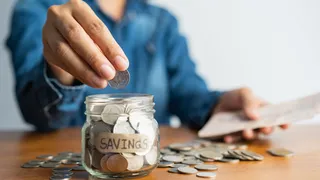 putting coin in savings jar