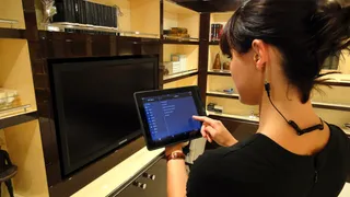 A yacht purser works off an iPad