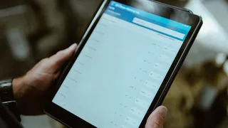 A photo of a technician holding a tablet.
