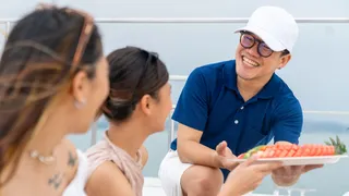 Superyacht crew serving charter guests on deck to earn better tips